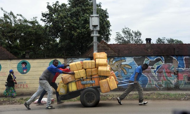 Three men transport water for sale in Mbotela area, Nairobi, capital of Kenya, April 5, 2021.(Photo: Xinhua)