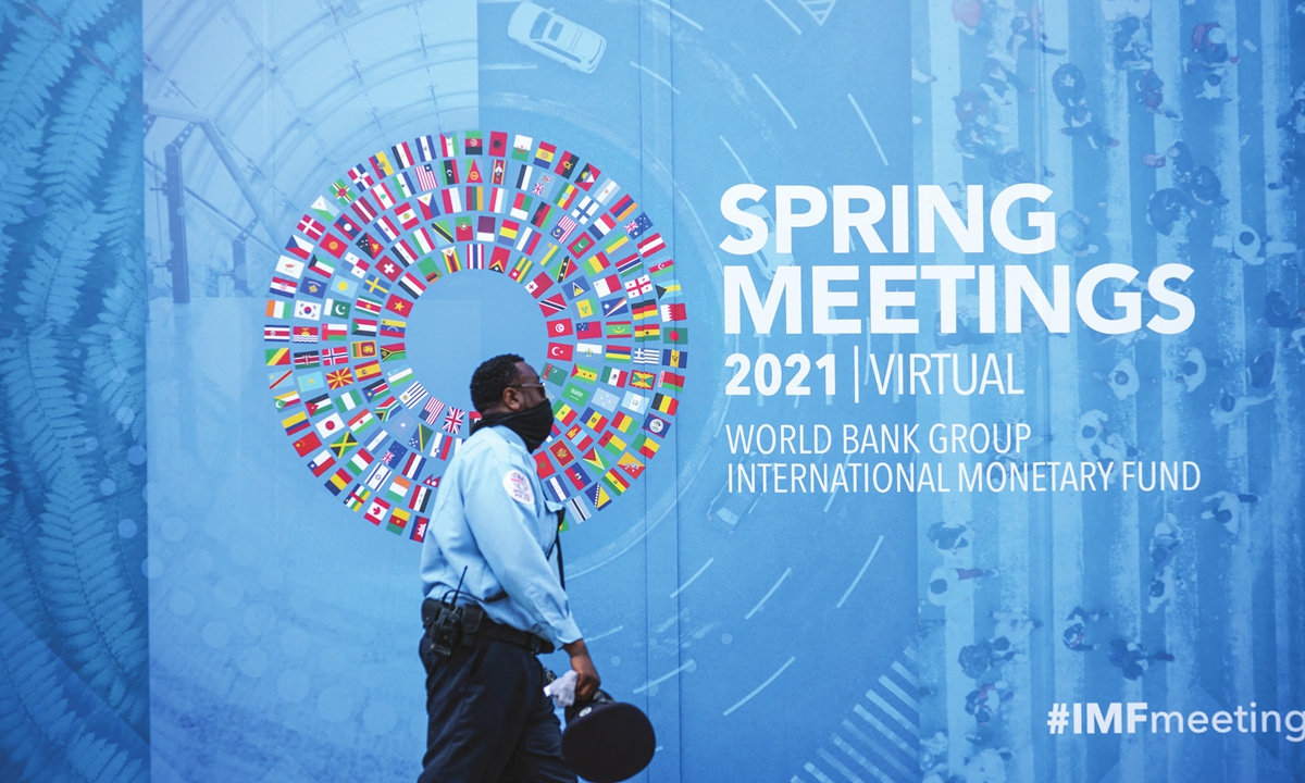 A man walks past a banner for the World Bank Group/International Monetary Fund Virtual Spring Meetings in Washington DC, the US, on Wednesday. Photo: AFP