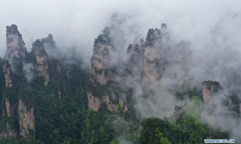 Aerial photo taken on April 7, 2021 shows the mountains shrouded by cloud and mist in Zhangjiajie National Forest Park, central China's Hunan Province.(Photo: Xinhua)