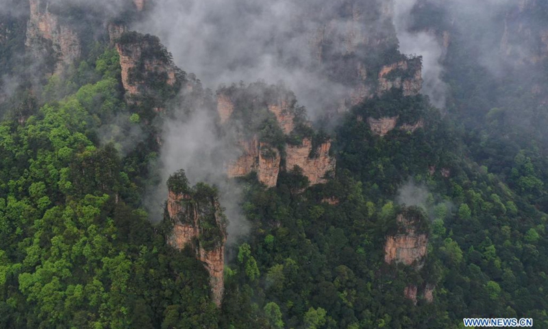Aerial photo taken on April 7, 2021 shows the mountains shrouded by cloud and mist in Zhangjiajie National Forest Park, central China's Hunan Province.(Photo: Xinhua)