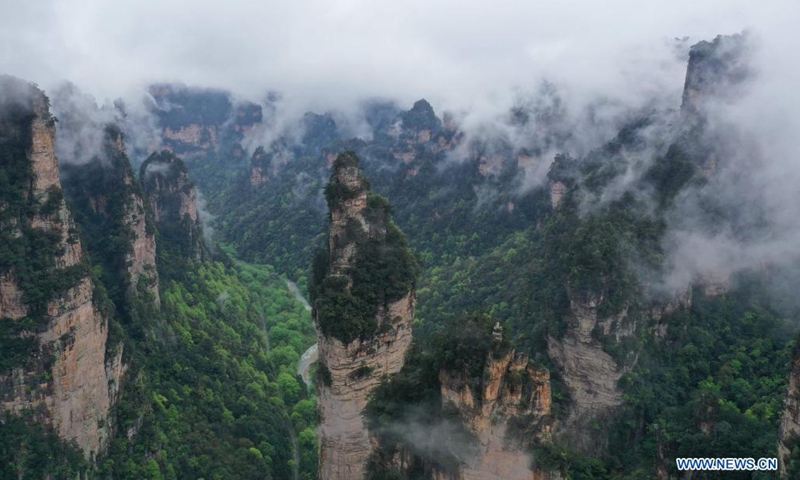 Aerial photo taken on April 7, 2021 shows the mountains shrouded by cloud and mist in Zhangjiajie National Forest Park, central China's Hunan Province.(Photo: Xinhua)