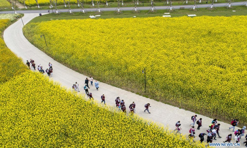 Students enjoy flowers in Huai'an, east China's Jiangsu Province, April 7, 2021.(Photo: Xinhua)