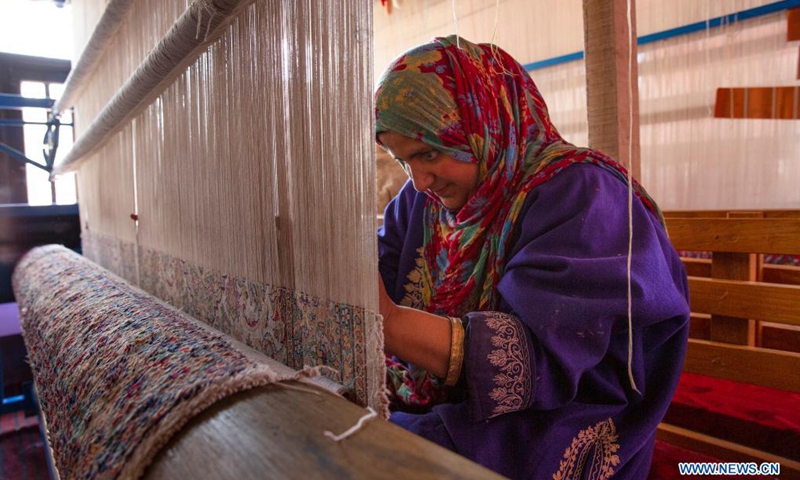 A woman works at a carpet-weaving workshop in Kokernag village of Anantnag district in Srinagar city, the summer capital of Indian-controlled Kashmir, April 7, 2021.(Photo: Xinhua)