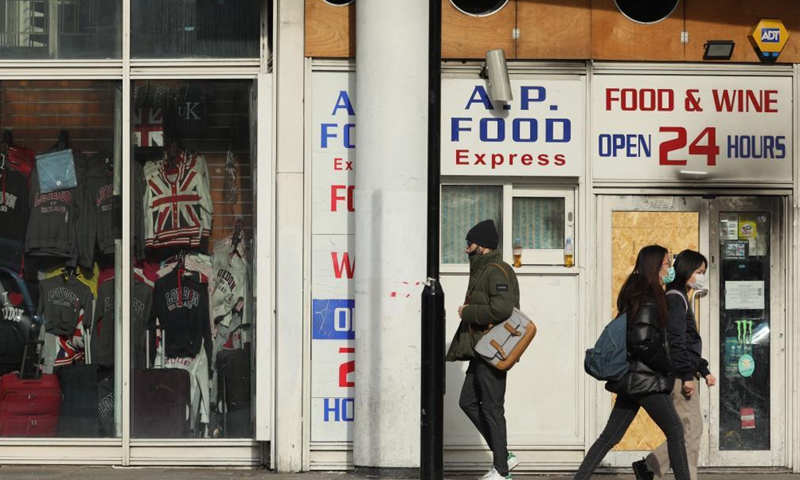 People walk past a closed shop near London Waterloo train station in London, Britain, on April 9, 2021. COVID-19 deaths in Europe surpassed the one million mark on Friday, reaching 1,001,313, according to the dashboard of the World Health Organization's Regional Office for Europe.Photo:Xinhua