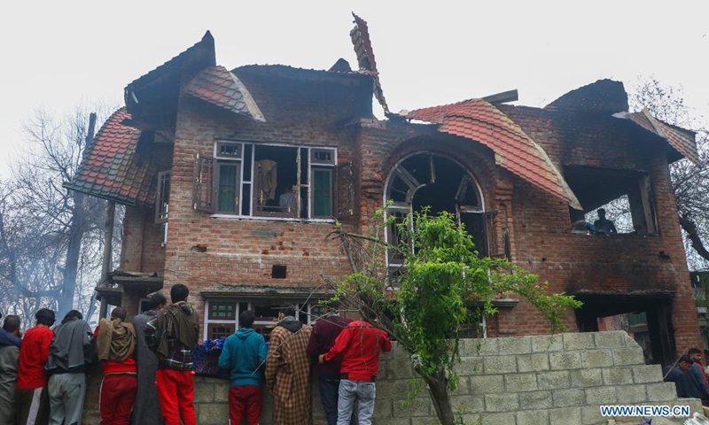 People gather near a house damaged during a fierce gunfight in Semthan-Bijbehara of Anantnag district, about 44 km south of Srinagar city, the summer capital of Indian-controlled Kashmir, April 11, 2021.(Photo: Xinhua)