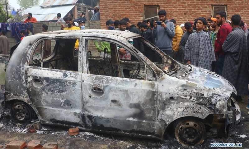 People gather near a car damaged during a fierce gunfight in Semthan-Bijbehara of Anantnag district, about 44 km south of Srinagar city, the summer capital of Indian-controlled Kashmir, April 11, 2021.(Photo: Xinhua)