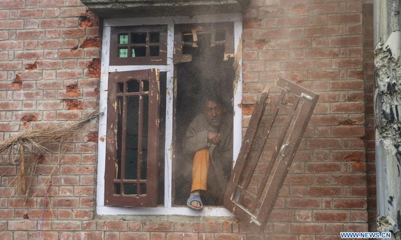 A man looks out from a window of a house damaged during a fierce gunfight in Semthan-Bijbehara of Anantnag district, about 44 km south of Srinagar city, the summer capital of Indian-controlled Kashmir, April 11, 2021.(Photo: Xinhua)