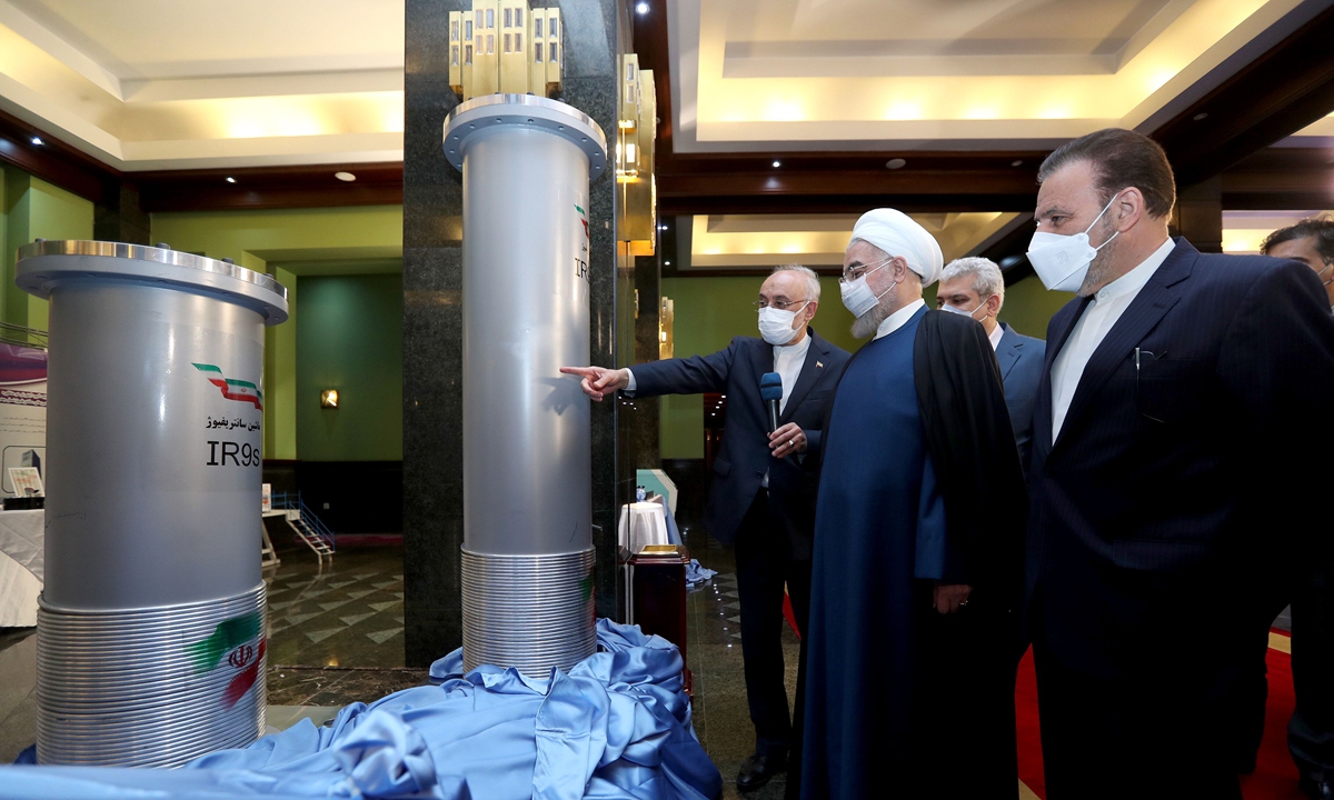 President of Iran, Hassan Rouhani (2nd right) and head of the Atomic Energy Organization of Iran Ali Akbar Salehi (left) visit a Nuclear Technology exhibition on the 11th anniversary of National Nuclear Technology Day in Tehran, Iran on Saturday. Meanwhile US and Iranian officials clashed over what sanctions the US should lift to resume compliance with the 2015 nuclear deal. Photo: VCG
