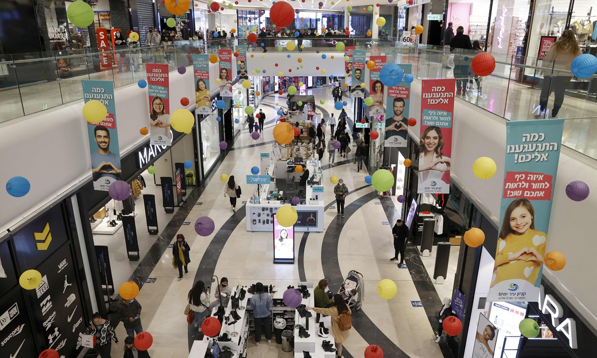 People visit a shopping mall in the Israeli coastal city of Netanya on February 21. Photo: VCG