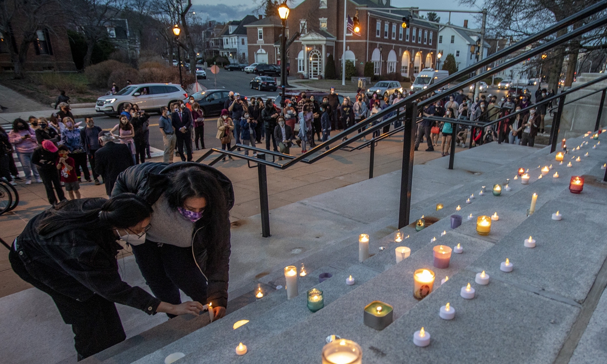 Protesters place candles at steps during 'Stop Asian Hate' Rally at Nubian Square in Malden on March 26. Photo: VCG 