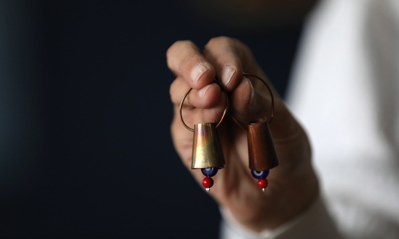 A Palestinian Rawan Raafat Rawan Raafat from East Jerusalem shows bell earrings at her own shop on April 12, 2021. (Photo: Xinhua)