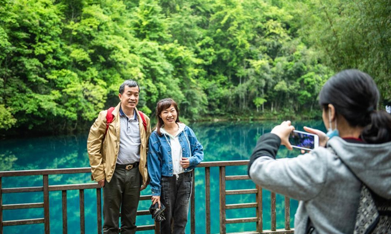 Tourists take photos at Xiaoqikong scenic spot in Libo County, southwest China's Guizhou Province, April 15, 2021. Photo: Xinhua