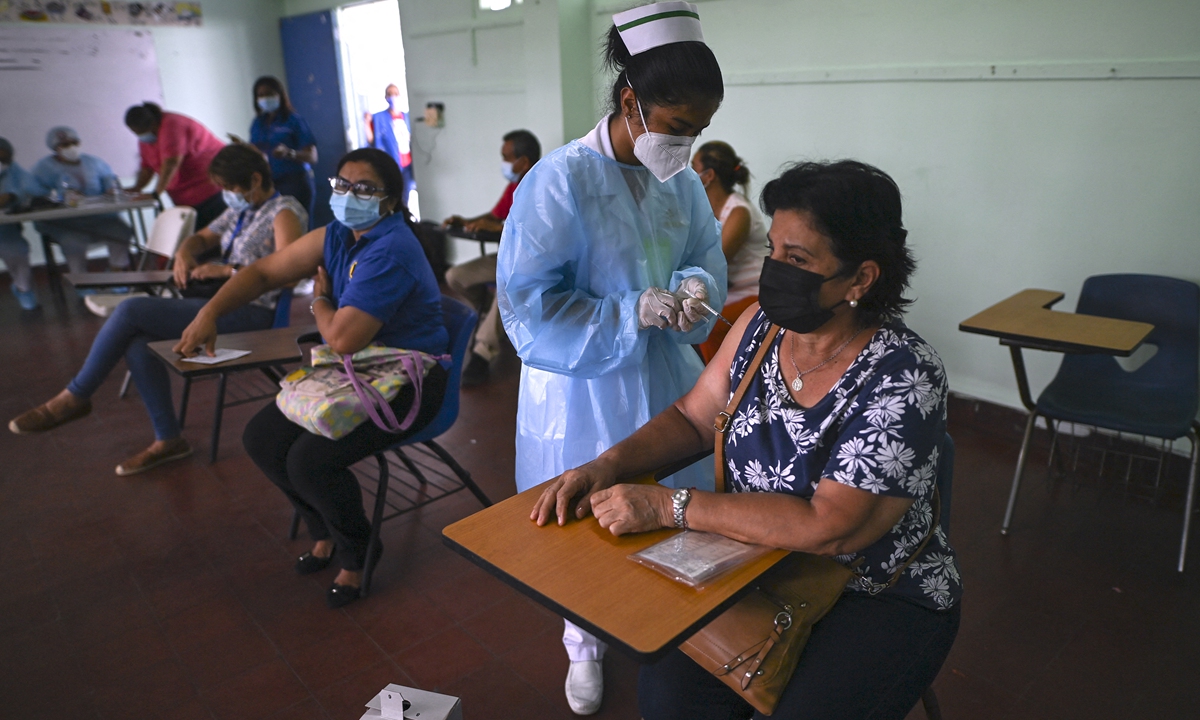A woman receives a second dose of the Pfizer-BioNTech vaccine against COVID-19 amid the novel coronavirus pandemic, at the Belisario Porras school San Francisco neighborhood in Panama City, Panama on Monday. The country registered 181 new cases on Monday. Photo: AFP