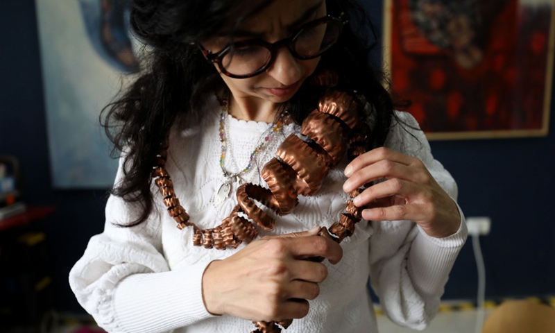 A Palestinian Rawan Raafat from East Jerusalem wears traditional jewelry at her own shop on April 12, 2021.(Photo: Xinhua)
