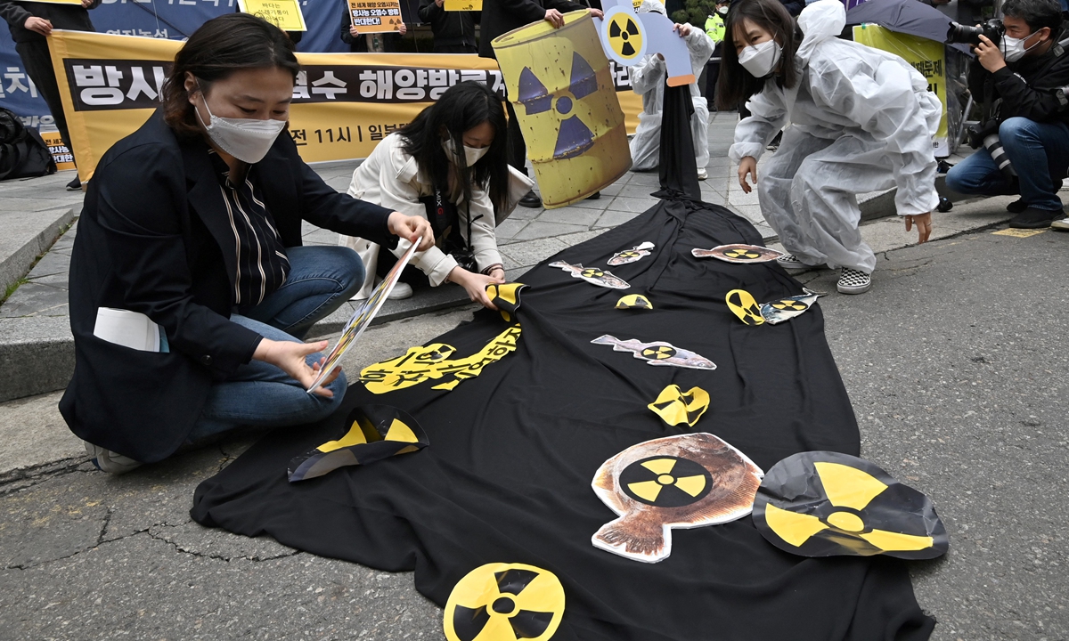 South Korean environmental activists display pictures of fishes with radioactivity warning signs during a protest against Japan's decision on releasing Fukushima wastewater, near the Japanese embassy in Seoul on April 13, 2021. Photo: AFP