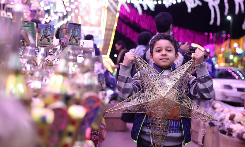 A boy poses for a photo at a lantern market in Cairo, Egypt, April 11, 2021.(Photo: Xinhua)
