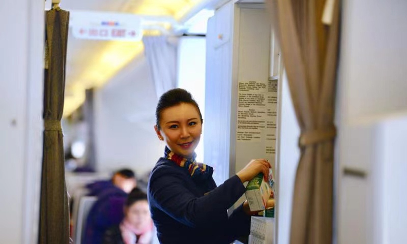 Lv Han works inside an airplane cabin before the outbreak of the COVID-19 pandemic. Photo: Courtesy of Air China  