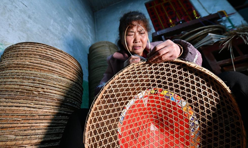 A villager works at a bamboo hat workshop in Shangjie Village of Sansui County, southwest China's Guizhou Province, April 11, 2021. With over 400-year of bamboo hat making history, Sansui County has taken the development of bamboo hat industry to enrich the people living there. (Xinhua)