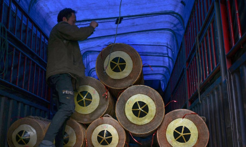 A trader loads bamboo hats on the truck in Shangjie Village of Sansui County, southwest China's Guizhou Province, April 11, 2021. With over 400-year of bamboo hat making history, Sansui County has taken the development of bamboo hat industry to enrich the people living there. (Xinhua)