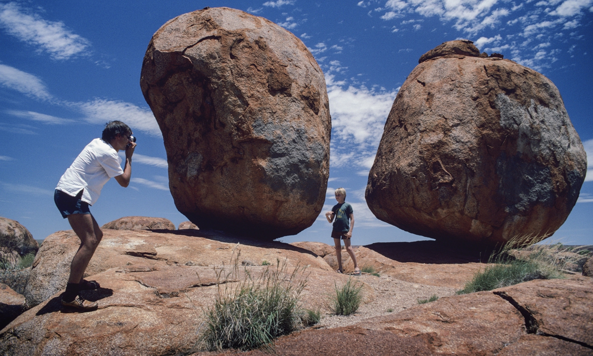 Tourists taking photographs at Devil's Marbles in the Northern Territory of Australia. Photo: VCG