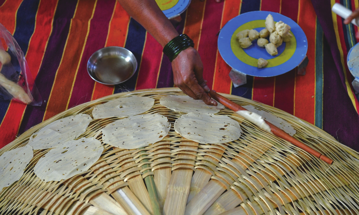 A member of Lijjat Papad rolls papadums at one of the organization's facilities in Mumbai, India, on March 8. Photo: AFP