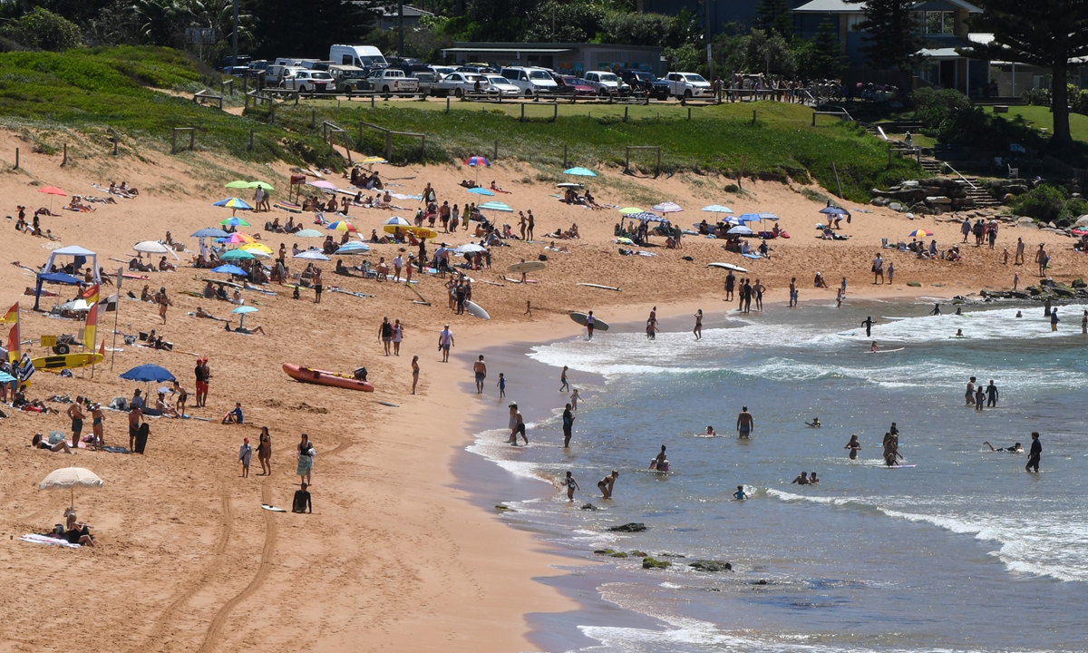 People enjoy the afternoon sunshine at Avalon Beach on January 10 in Sydney, Australia. Photo: VCG
