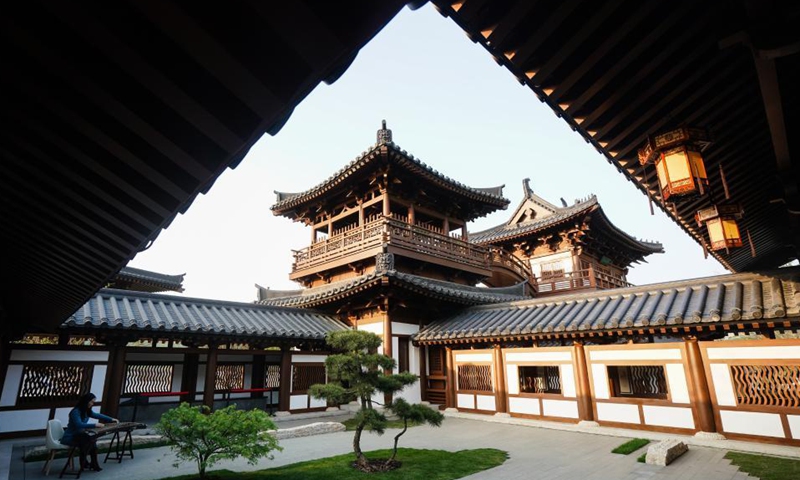 A performer plays Guzheng at the Garden Expo Park in Jiangning District of Nanjing, east China's Jiangsu Province, April 15, 2021. The 11th Horticultural Exposition of Jiangsu Province opened in Jiangning, Nanjing, on Thursday. Jiangsu Garden Expo Park is built on abandoned mine pits. Through the revitalization of industrial remains, the once abandoned mine has become an urban oasis where man and nature coexist harmoniously. Photo: Xinhua