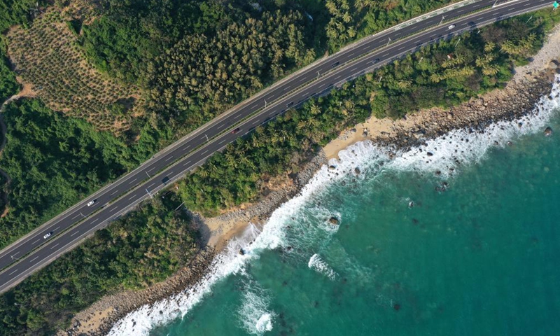 Aerial photo taken on Dec. 30, 2020 shows a view of a section of Hainan Ring Expressway in south China's Hainan Province. Hainan has made significant progress in the construction of expressway since the 13th Five-Year Plan, which started in 2016. By far, the total mileage of expressways in the province has reached 1,255 kilometers. The transport upgrade will help boost the building of Hainan into an international tourism and consumption center.Photo:Xinhua