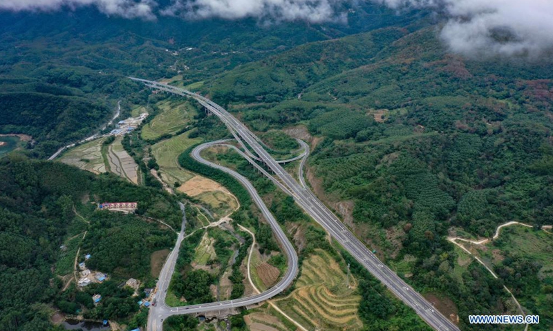 Aerial photo taken on Dec. 12, 2020 shows a view of a section of Haikou-Sanya Expressway in south China's Hainan Province. Hainan has made significant progress in the construction of expressway since the 13th Five-Year Plan, which started in 2016. By far, the total mileage of expressways in the province has reached 1,255 kilometers. The transport upgrade will help boost the building of Hainan into an international tourism and consumption center.Photo:Xinhua