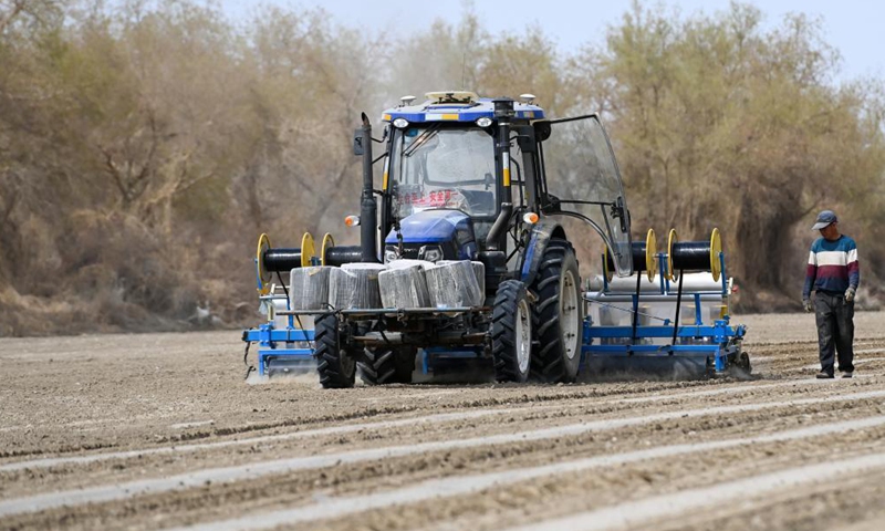 A film mulching sower is at work in a cotton field in Tungqeka Village of Xingping Township, Yuli County, Bayingolin Mongolian Autonomous Prefecture, northwest China's Xinjiang Uygur Autonomous Region, April 13, 2021.Photo:Xinhua