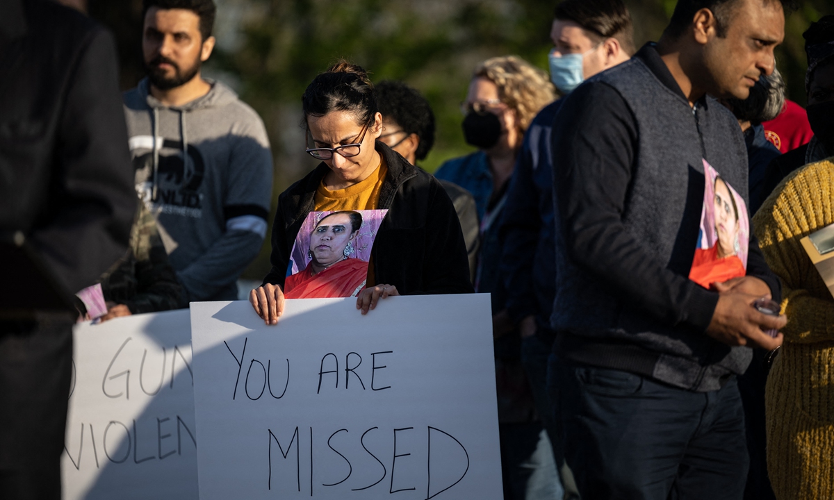 Family members of the deceased listen as Indianapolis Mayor Joe Hogsett delivers a speech to those gathering during a vigil to mourn the eight murdered FedEx Ground employees at Krannert Park on April 17, 2021 in Indianapolis, Indiana. Photo: AFP