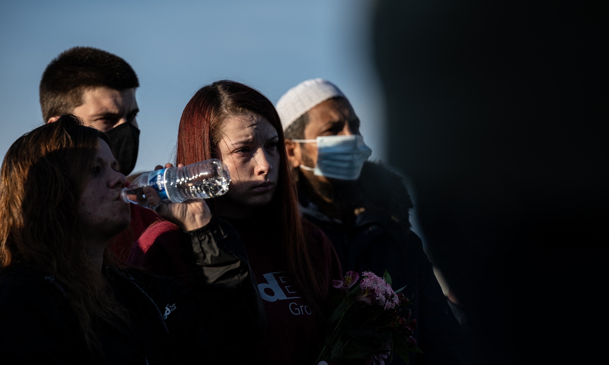 People bow their heads during a moment of prayer during a vigil to mourn the eight murdered FedEx Ground employees at Krannert Park on April 17, 2021 in Indianapolis, Indiana. Photo: AFP