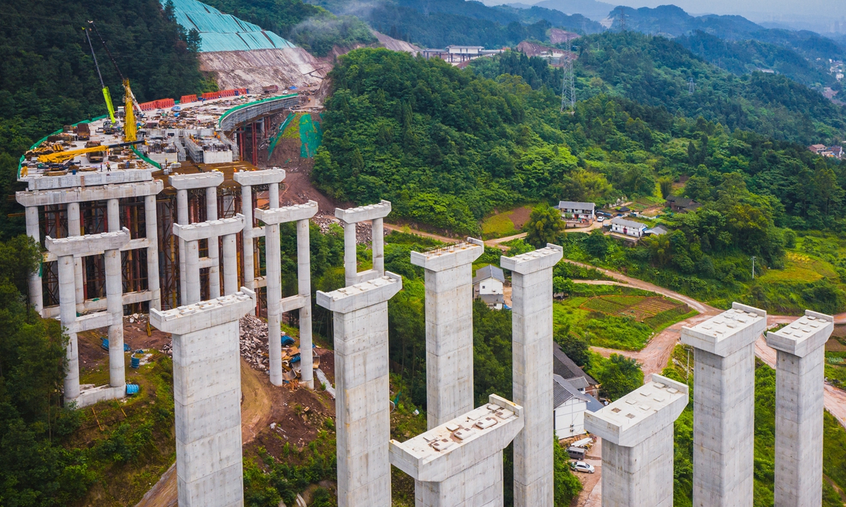 Workers push forward construction of a highway in Qijiang District, Southwest China's Chongqing Municipality during the May Day holidays. The road will offer a vital traffic link between the district and the urban area of Chongqing. As of 2020, China had the world's largest highway network totaling 160,000 kilometers in operation. Photo: VCG