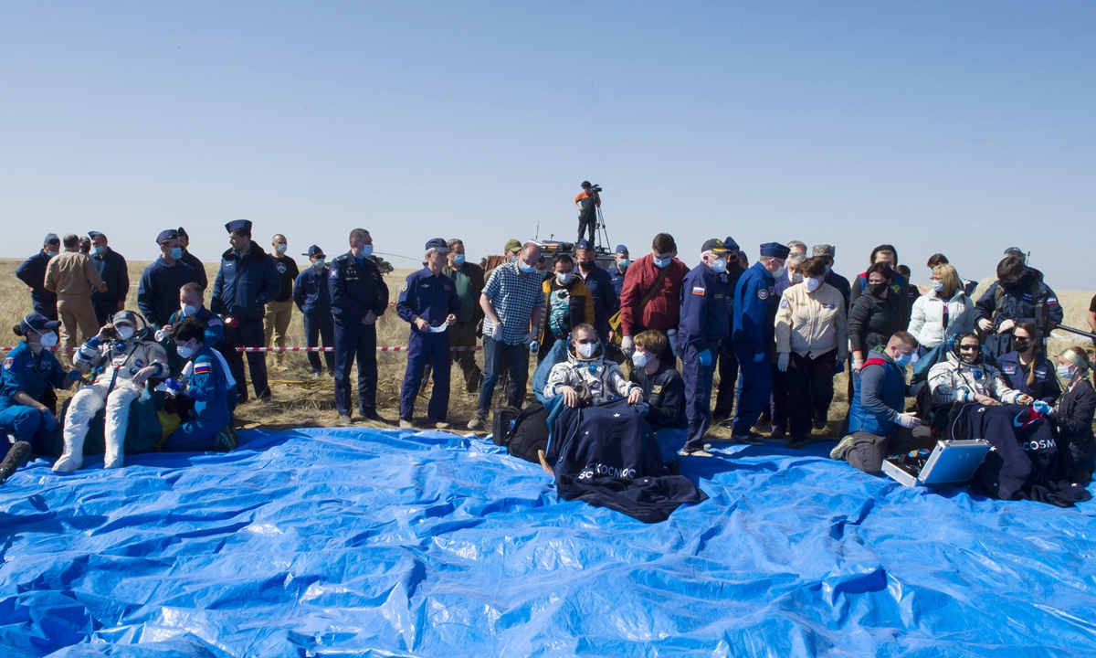 US astronaut Kate Rubins, and Russian cosmonauts Sergey Ryzhikov and Sergey Kud-Sverchkov sit in chairs shortly after the landing a Russian Soyuz MS-17 space capsule south-east of the Kazakh town of Zhezkazgan, Kazakhstan, Saturday, April 17, 2021. Photo: VCG 