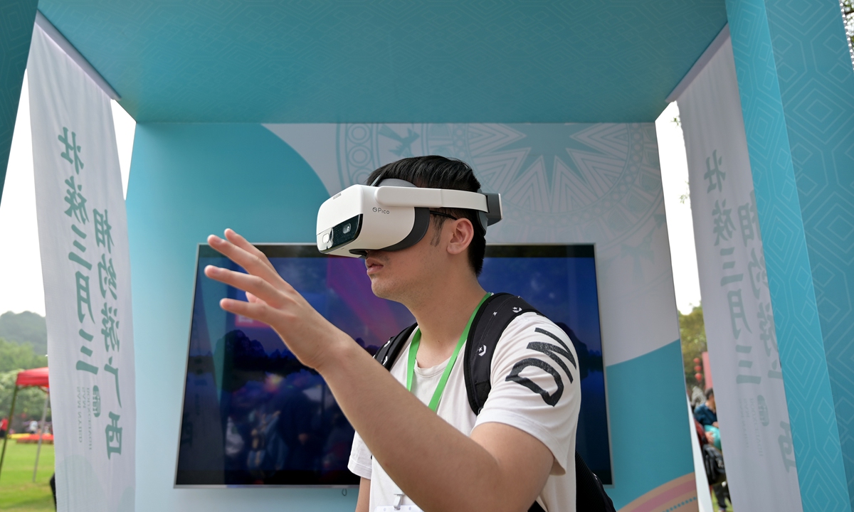 A visitor views the scenery in South China's Guangxi Zhuang Autonomous Region via virtual reality (VR) glasses. The region received 15.78 million visitors, up 3.1 percent year-on-year, during the March 3 Festival, a lunar festival of local ethnic groups, which runs from April 14-17 this year. Photo: cnsphoto