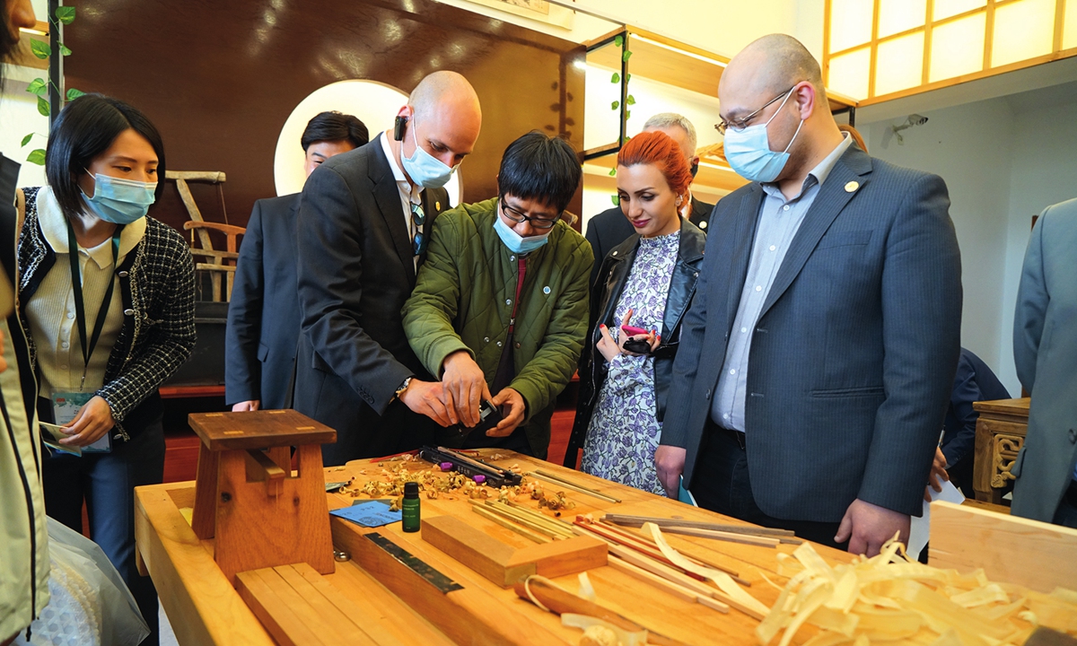 Foreign diplomats expereince woodcarving at Yucun village on April 15. Photo: Huang Lanlan/GT