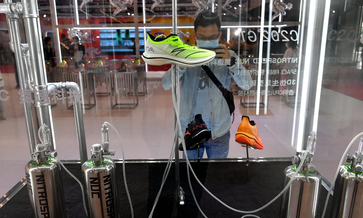 A visitor takes photos of a high-tech footwear exhibition during the 23rd Jinjiang Footwear & 6th International Sports Industry Exhibition held in Jinjiang, east China's Fujian Province, on Monday.  Photo: cnsphoto