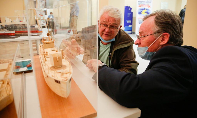 Two men talk to each other during the Russian Championship and Moscow Open Cup in ship modelling in Moscow, Russia, on April 18, 2021. More than 160 models of ships and vessels, from the smallest ones 10-15 centimeters long to large models over 1.5 meters long, were presented during the competition.(Photo: Xinhua)