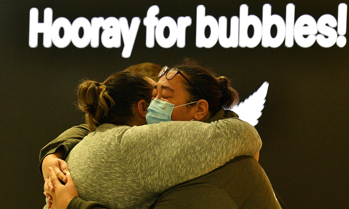 A woman (right) hugs a family member before her departure to New Zealand at Sydney International Airport on Monday, as Australia and New Zealand opened a trans-Tasman quarantine-free travel bubble. Photo: AFP