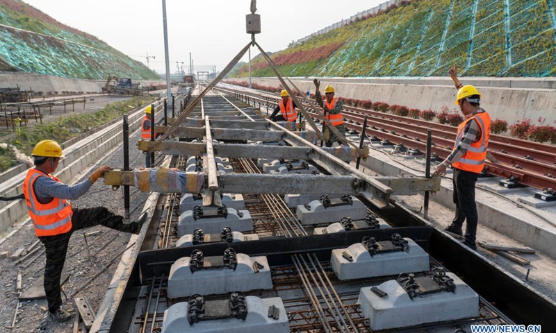 Workers work on the ballastless tracks at the construction site of Nanzhang Station of the Zhengzhou-Wanzhou high-speed railway in Nanzhang County, central China's Hubei Province, April 12, 2021. Photo: Xinhua 