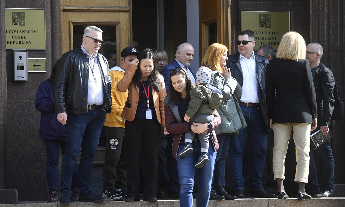Czech diplomats and their family members prepare to leave the grounds of the country's embassy in Moscow on Monday. Russia on Sunday announced the expulsion of 20 Czech diplomats a day after Prague's 