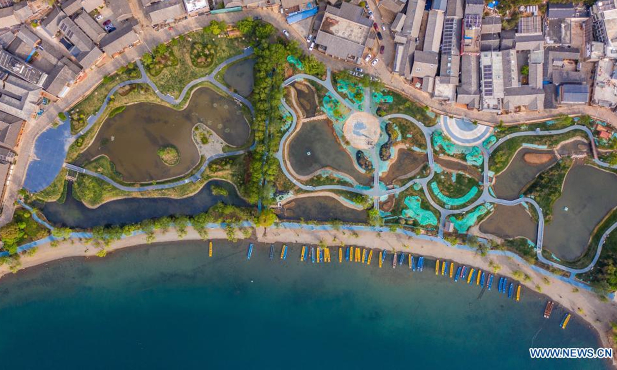 Aerial photo taken on April 17, 2021 shows a lakeside ecological belt construction and wetland restoration project by Lugu Lake in Lige Village, Yongning Town, Ninglang Yi Autonomous County, in southwest China's Yunnan Province. Bordering Sichuan province, Lugu is the highest lake in Yunnan, standing about 2,700 meters above sea level and surrounded by forest-clad mountains. (Xinhua/Hu Chao)