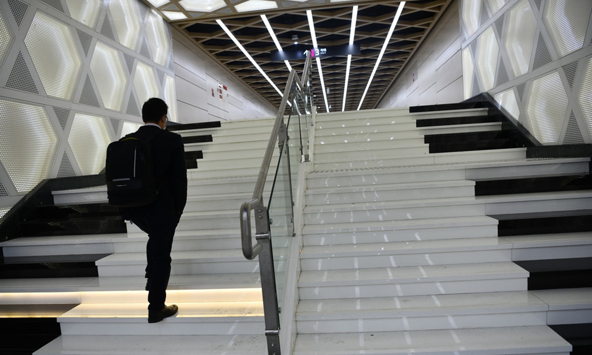 A man walks up the piano ladder at the entrance of a newly opened metro line for a music school in Chengdu, Southwest China's Sichuan Province Photo: IC