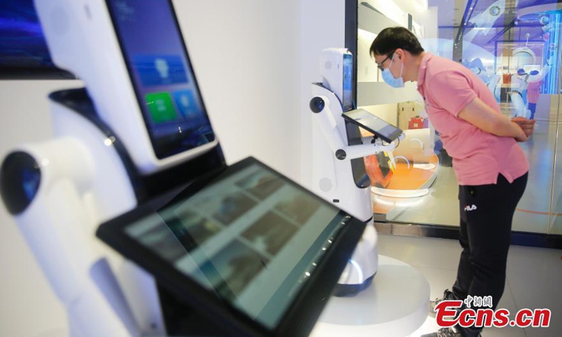 A visitor is having vocal communication with an intelligent robot at the exhibition hall of Guangdong Xinbao Electrical Appliances Company in Foshan, a manufacturing powerhouse in Guangdong-Hong Kong-Macao Greater Bay Area(GBA), April 19, 2021.   Photo: China News Service