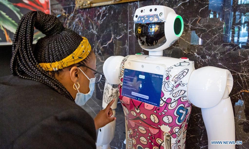A woman interacts with service robot named Lexi at the lobby of Sky Hotel in Johannesburg, South Africa, on April 19, 2021. Lexi was introduced to provide non-contact services to hotel dwellers in response to the on-going COVID-19 pandemic. (Photo: Xinhua)