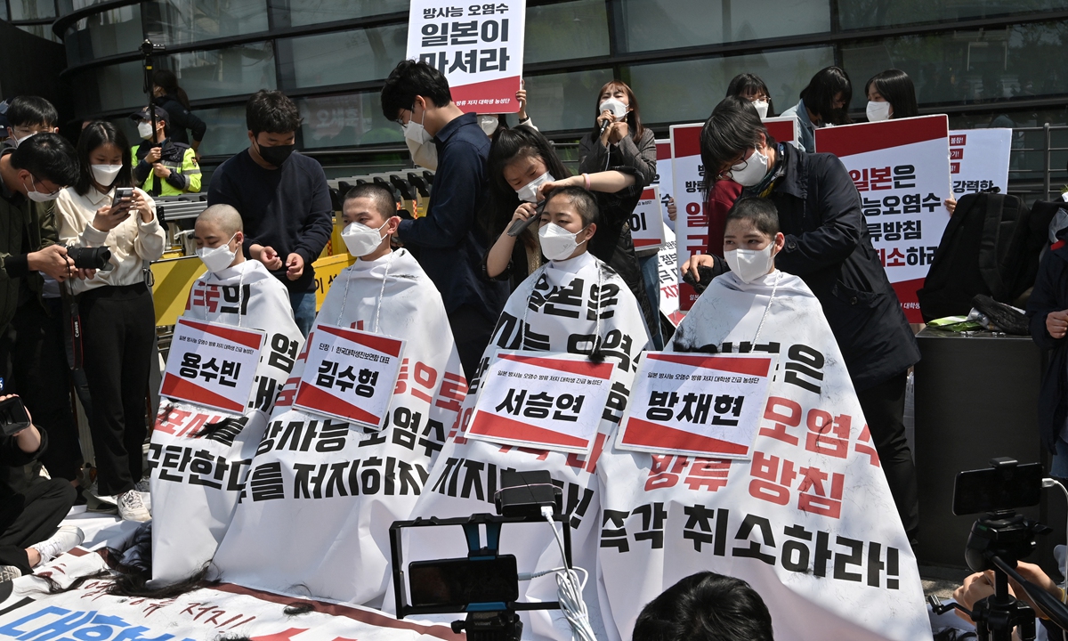 South Korean protesters have their heads shaved during a protest against the Japanese government's decision to dump nuclear-contaminated water from the stricken Fukushima Daiichi nuclear plant into the sea, in front of the Japanese Embassy in Seoul on Tuesday. Photo: AFP