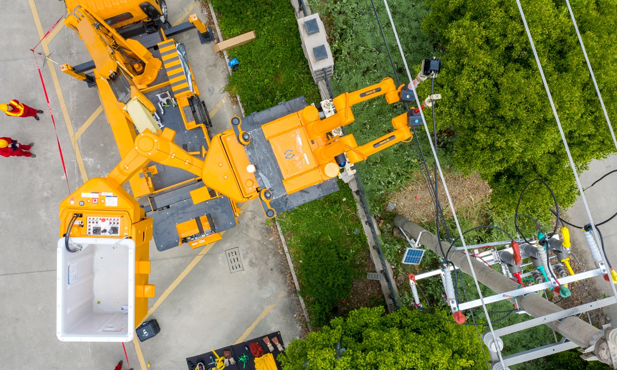 A robot performs autonomous wire connection work powered by 10 kilovolts of energy in Huzhou, East China's Zhejiang Province on Tuesday. The robot has improved safety, reliability and productivity, and realized the transformation and upgrading of traditional work to digital intelligence. Photo: cnsphoto