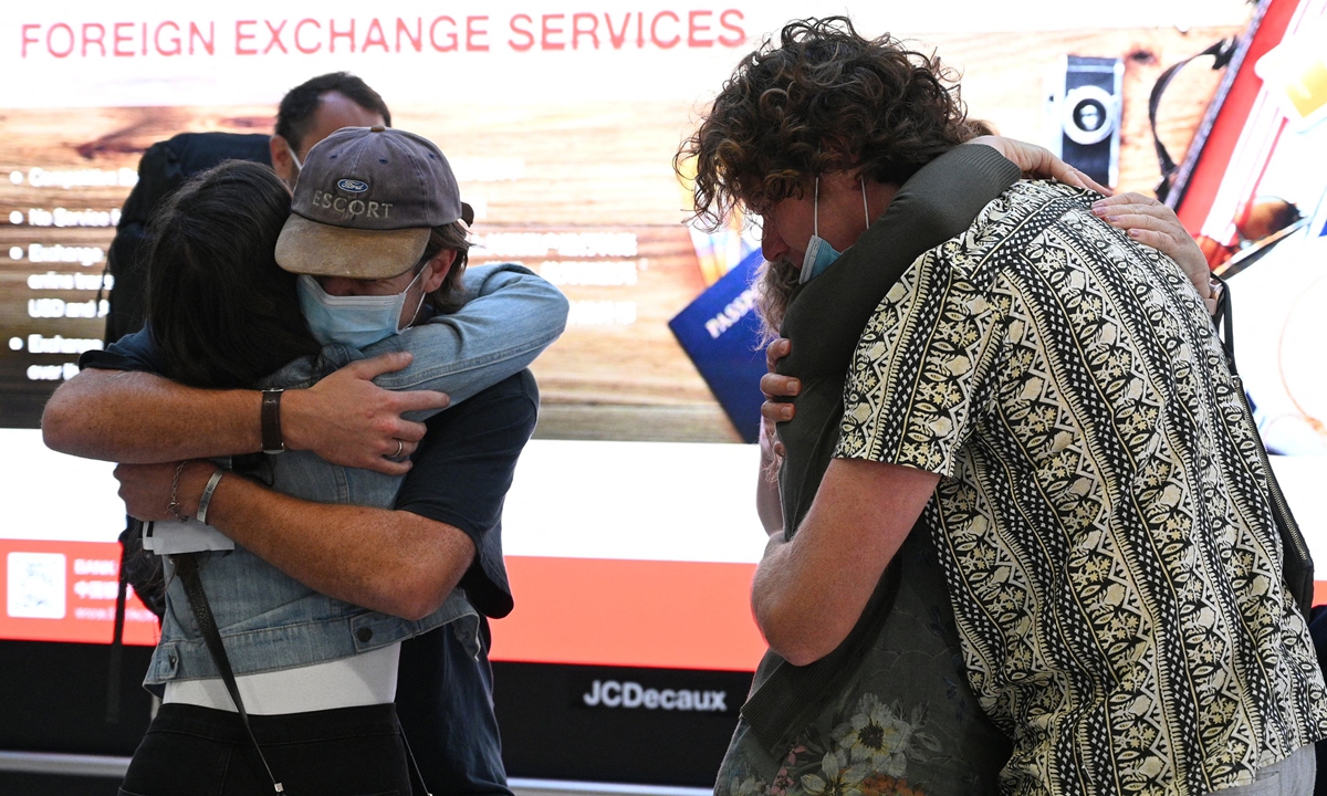 Family members embrace each other upon their arrival from New Zealand at Sydney Airport on Monday. Photo: VCG