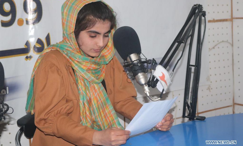 An Afghan female journalist hosts a radio program at the radio-television channel Ghazal in Shiberghan city, capital of Jawzjan province, Afghanistan, April 7, 2021.(Photo: Xinhua)