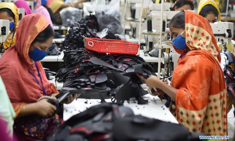 Workers make shoes at the factory of Panda Shoes Industries Ltd. in Gazipur on the outskirts of Dhaka, Bangladesh, April 4, 2021. Thousands of households in the Gazipur District on the outskirts of the Bangladeshi capital Dhaka have become better off after a Chinese-invested shoemaking factory opened there in 2012. Panda Shoes Industries Ltd. has not only brought investment and development opportunities to the Gazipur District, but also provided jobs at villagers' doorsteps.(Photo: Xinhua)